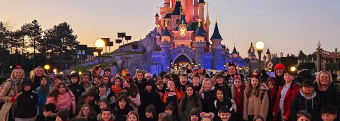 Exwick Heights Primary School stood in Disney Land Paris, with a magical castle in the background. 